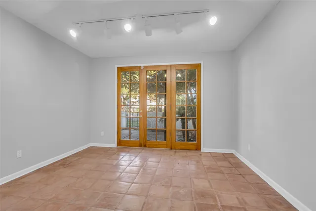 a view of an empty room with a fireplace and a window