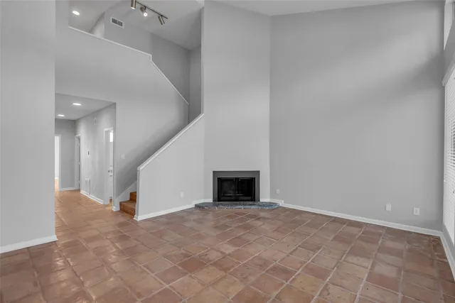 wooden floor in an empty room with a fireplace