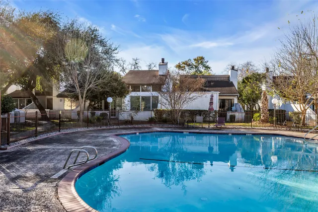 a view of a swimming pool with outdoor seating