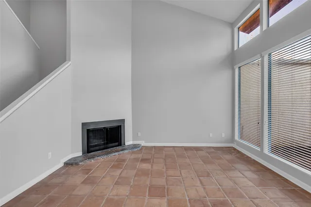 a view of empty room with a fireplace