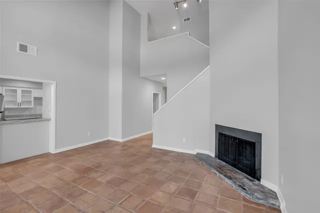 a view of an empty room with a fireplace