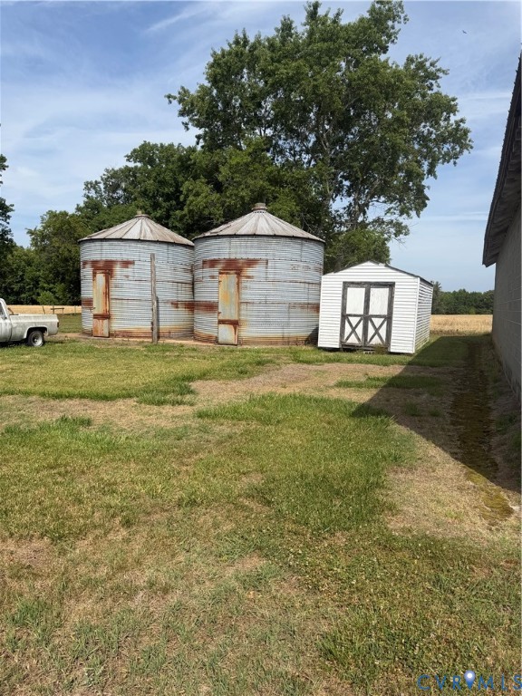 9380 Wakefield Road Wakefield, VA 23888 - Photo 6 of 11 Two galvanized metal grain silos featuring conical