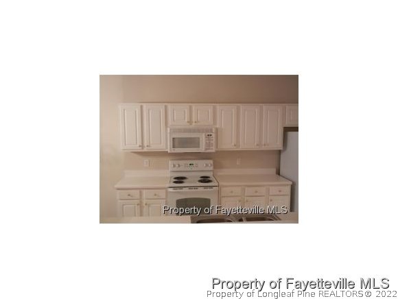 532-7 Lionshead Road Fayetteville, NC 28311 - Photo 9 of 21 a kitchen with kitchen island sink and cabinets