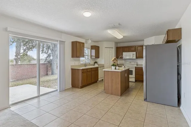 a kitchen with a sink a counter top space cabinets and stainless steel appliances