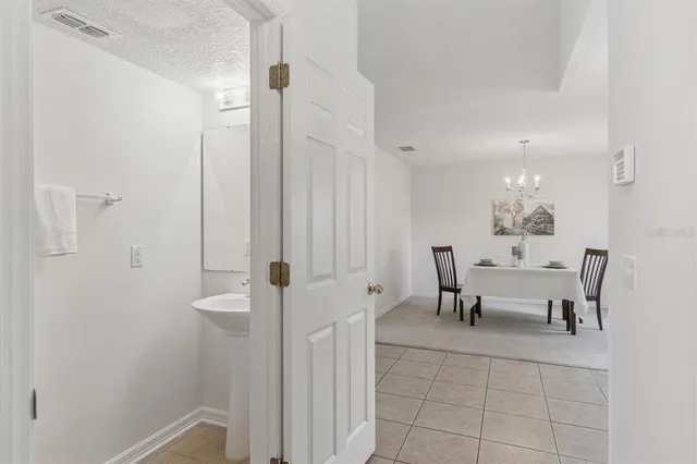 a dining room with furniture and a chandelier