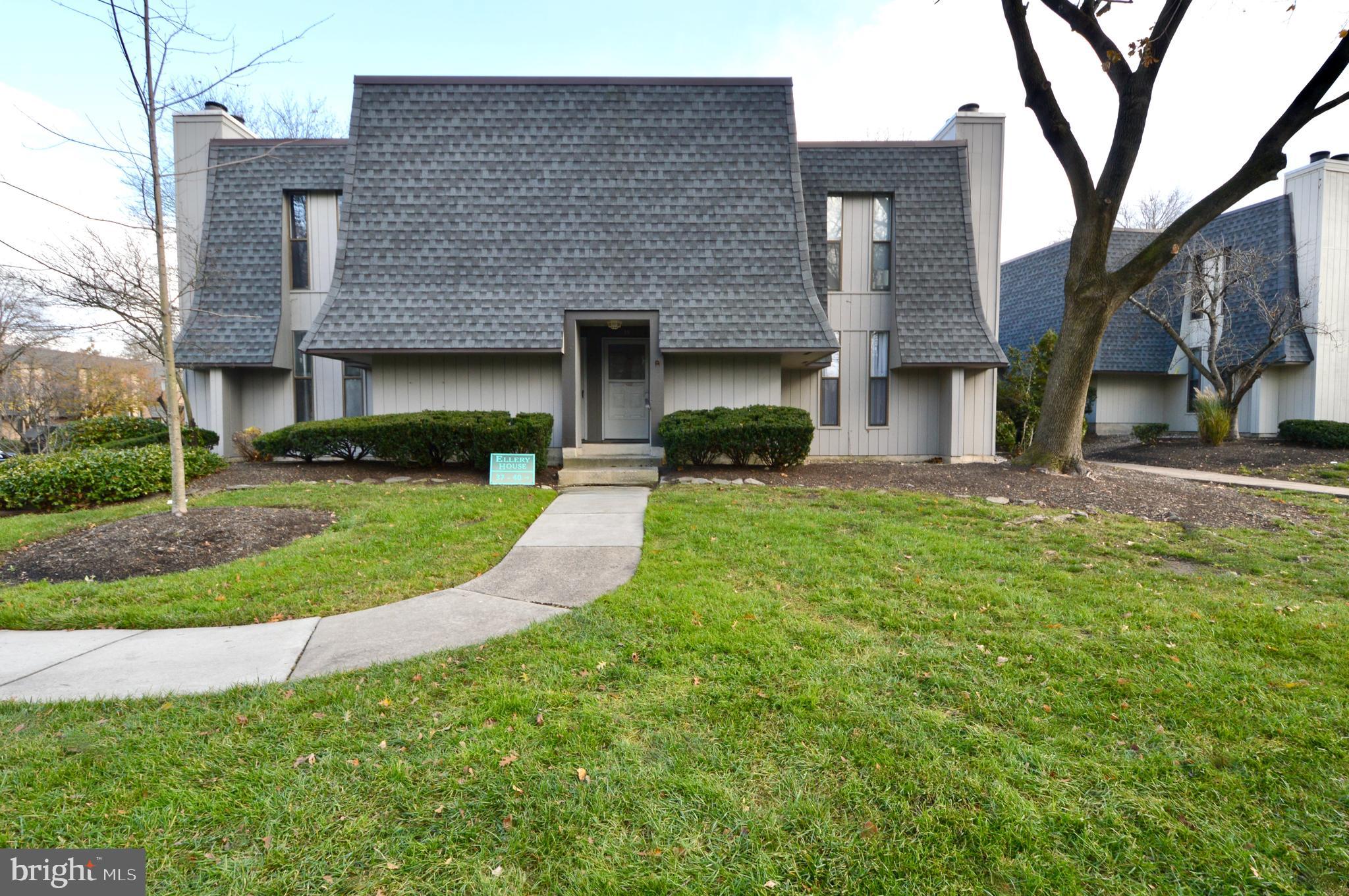 a view of a brick house with a yard