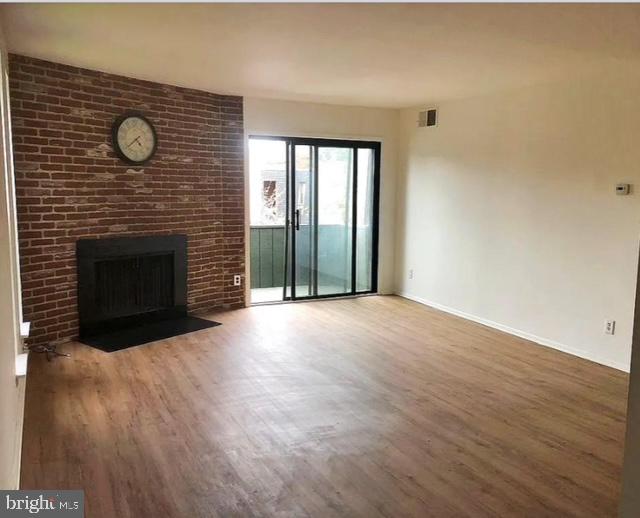 25 South Church Road, Unit 38 Maple Shade, NJ 08052 - Photo 4 of 20 a view of empty room with wooden floor and fireplace