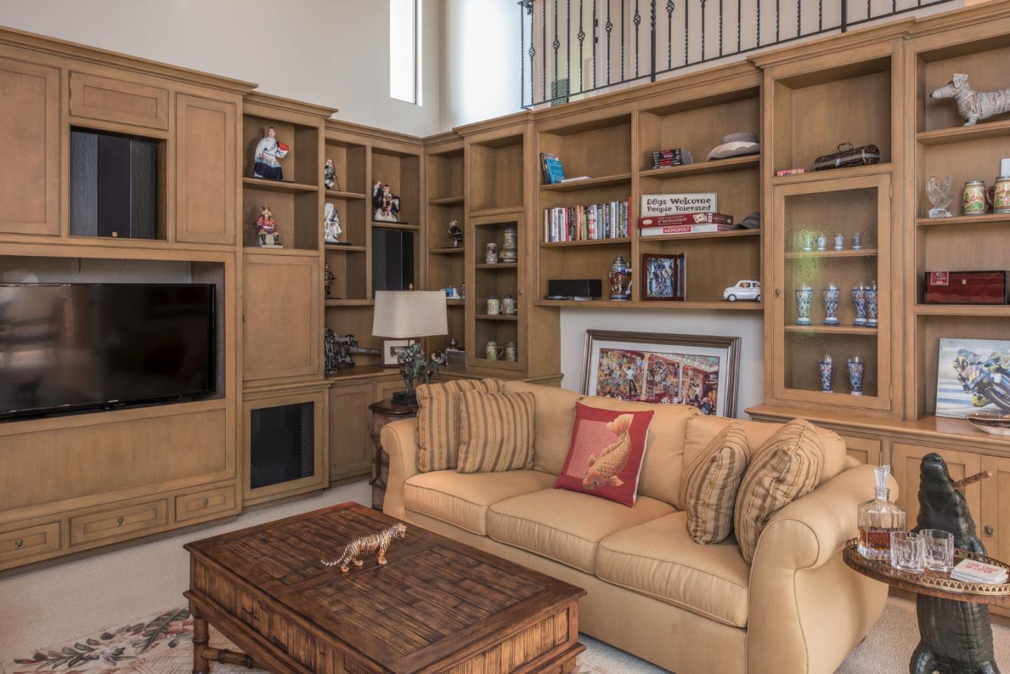 3025 Bird Rock Road Pebble Beach, CA 93953 - Photo 12 of 25 a living room with furniture a flat screen tv and a fireplace
