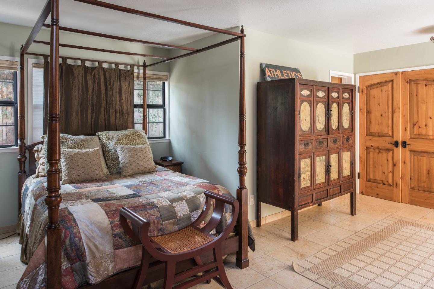 3025 Bird Rock Road Pebble Beach, CA 93953 - Photo 15 of 25 a bedroom with a bed closet and a large mirror
