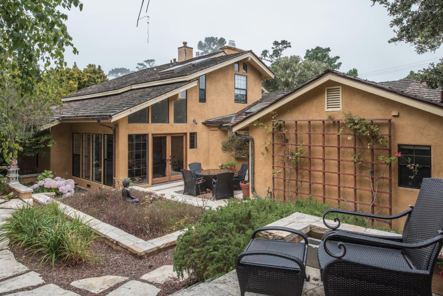 3025 Bird Rock Road Pebble Beach, CA 93953 - Photo 21 of 25 a view of a house with backyard sitting area and garden