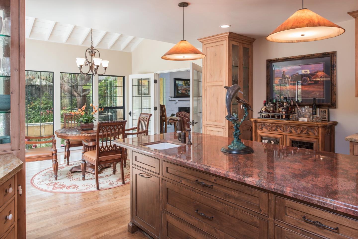 3025 Bird Rock Road Pebble Beach, CA 93953 - Photo 8 of 25 a dining hall with couches a flat tv screen and a dining table with garden view