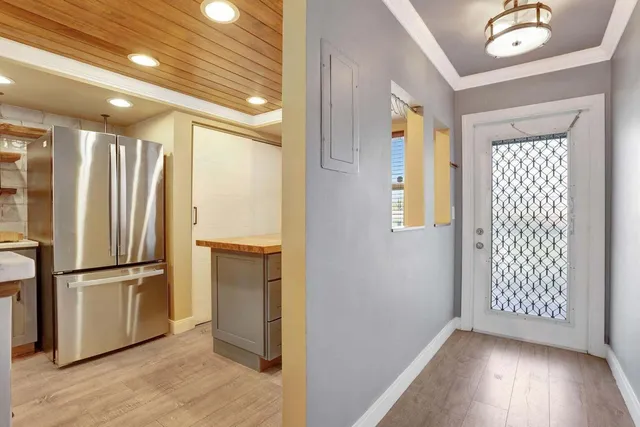 a view of a hallway with wooden floor and staircase