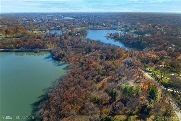 an aerial view of residential house with outdoor space and lake view