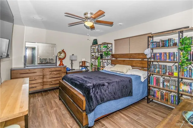 a bedroom with a bed and a book shelf