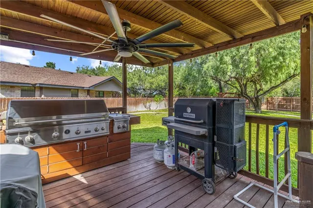 a view of a chairs and table in the patio next to a yard