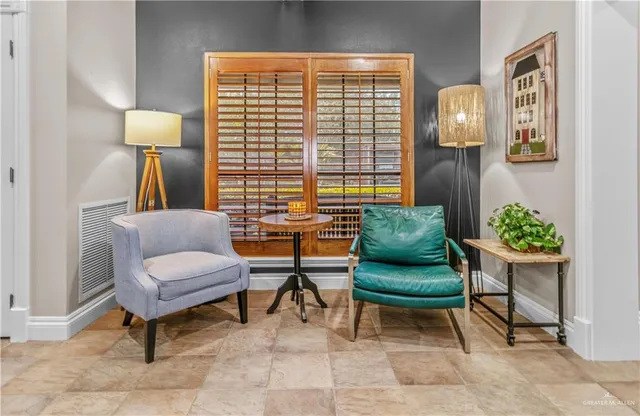 a living room with furniture and a potted plant