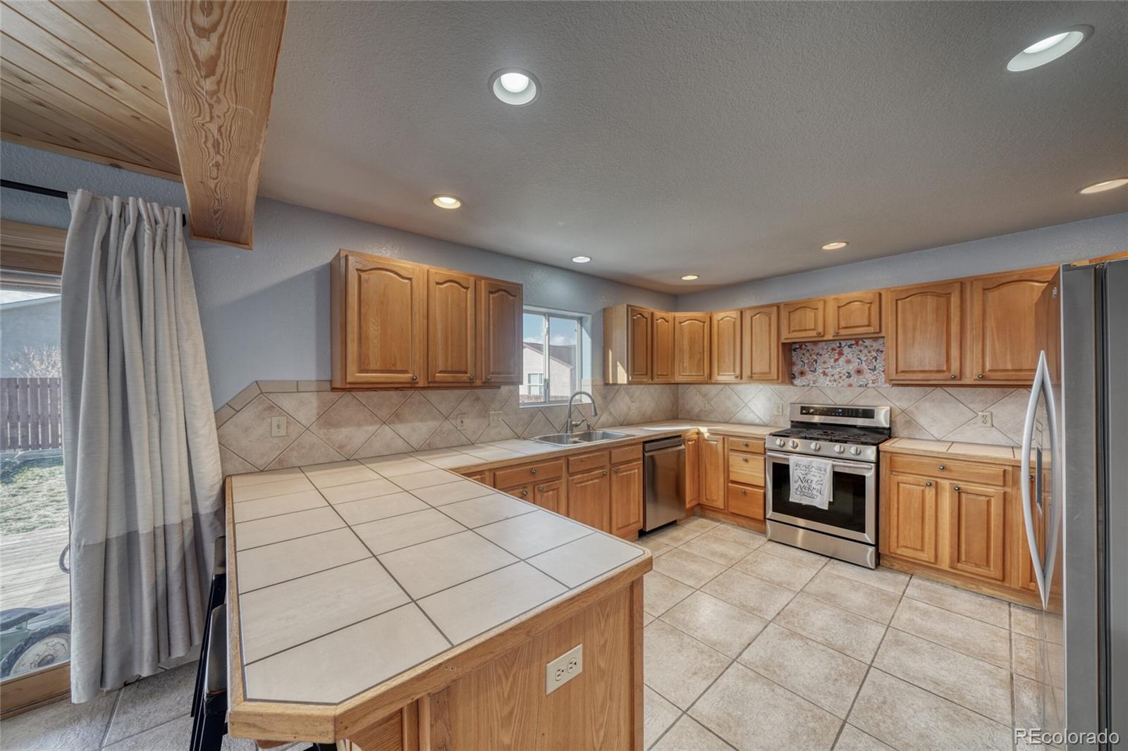 50 Rex Circle Salida, CO 81201 - Photo 18 of 50 a kitchen with a sink a stove top oven and cabinetry