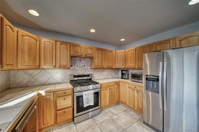 a kitchen with a refrigerator sink and stove