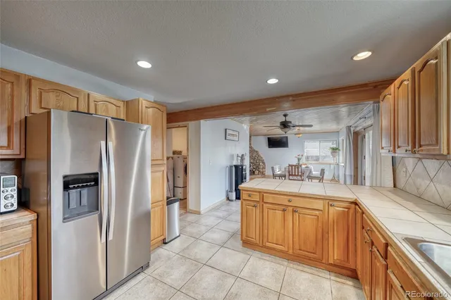 a kitchen with stainless steel appliances granite countertop a refrigerator and a sink