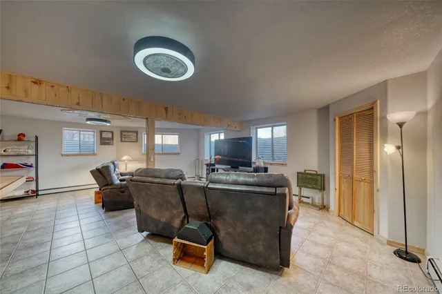 a view of a dining room with furniture a chandelier and window