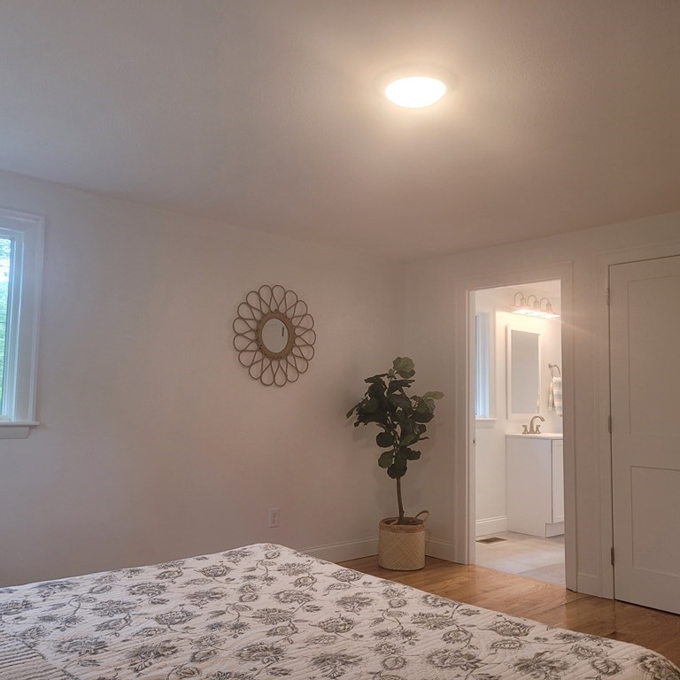 54 Summer Street North Andover, MA 01845 - Photo 19 of 25 a view of a bedroom with a bed and a window