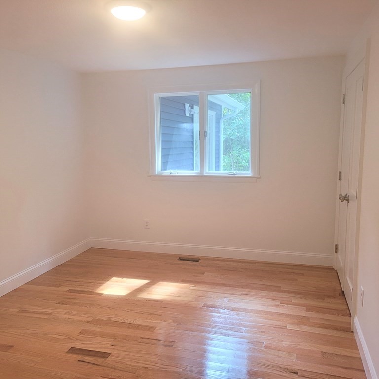 54 Summer Street North Andover, MA 01845 - Photo 22 of 25 wooden floor in an empty room with a window