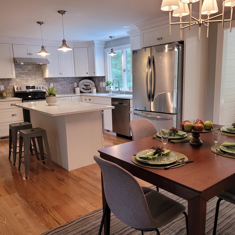 54 Summer Street North Andover, MA 01845 - Photo 7 of 25 a kitchen with stainless steel appliances granite countertop a sink stove and refrigerator with wooden floor