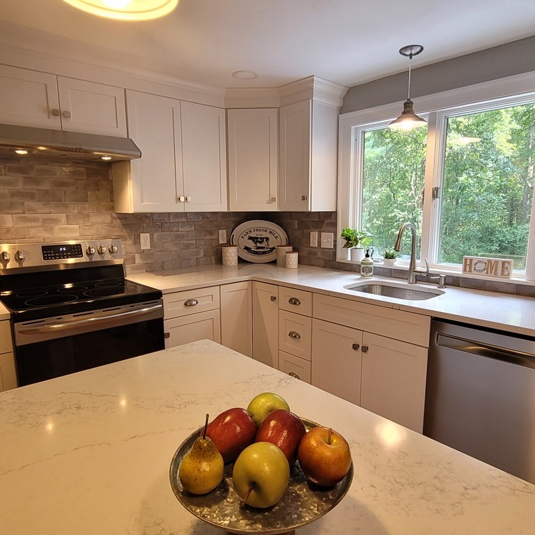 54 Summer Street North Andover, MA 01845 - Photo 9 of 25 a kitchen with a sink a stove and cabinets
