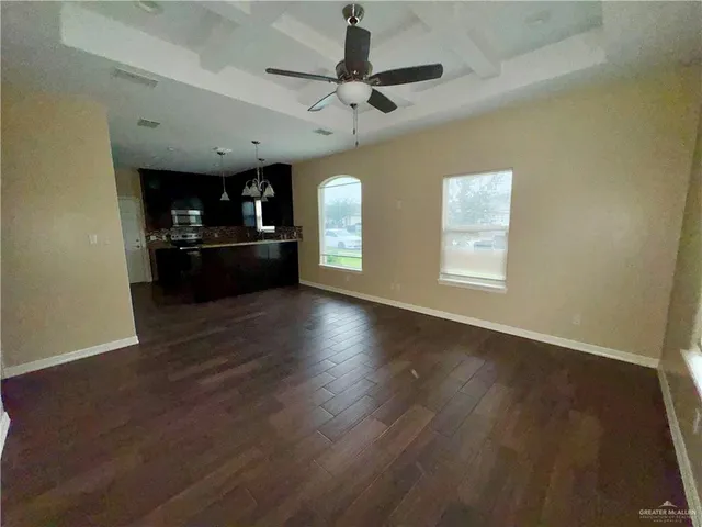 a view of a living room a window and wooden floor
