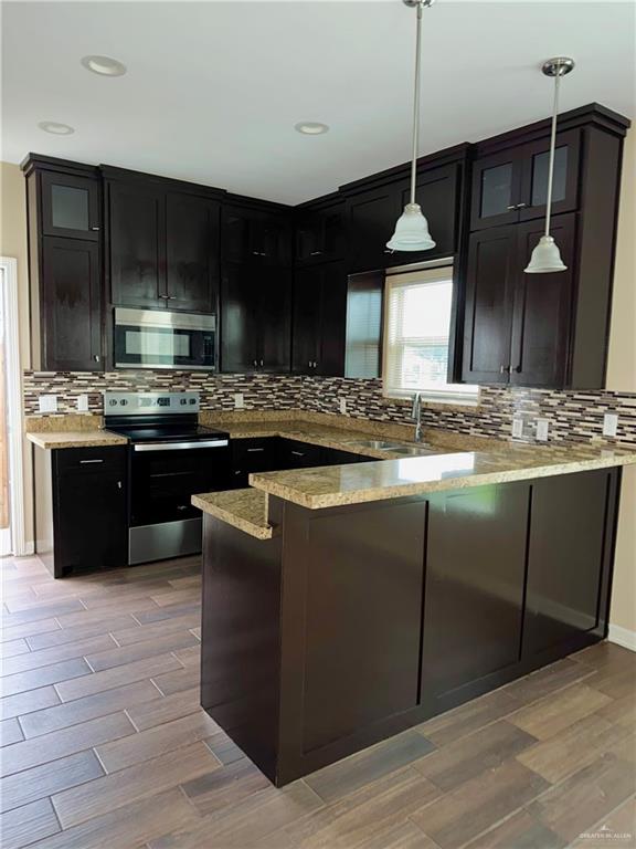 2004 Taft Street, Unit 1 Weslaco, TX 78599 - Photo 4 of 16 a kitchen with kitchen island granite countertop a sink a counter top space and cabinets