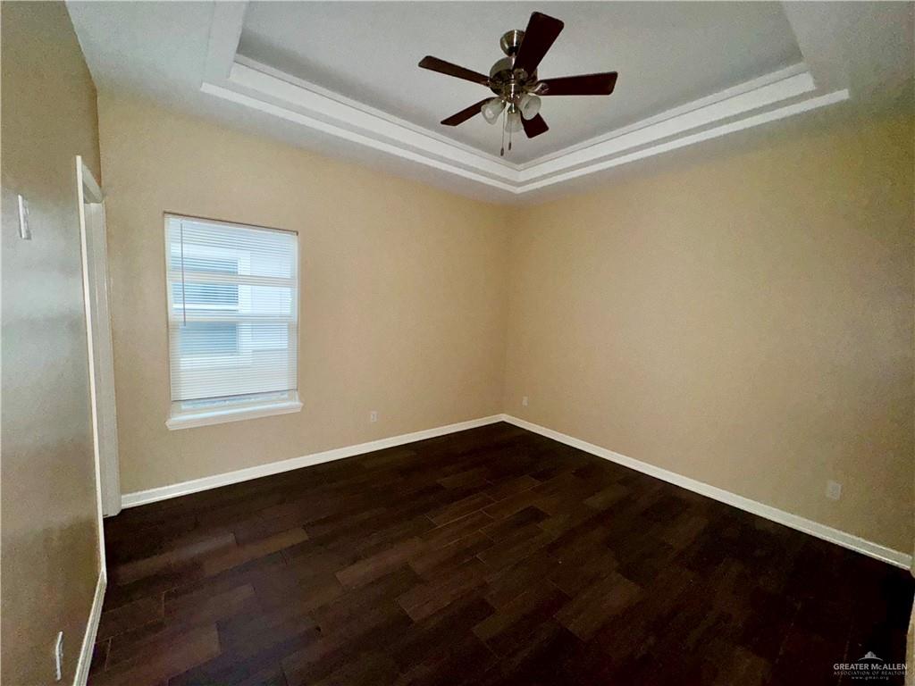 2004 Taft Street, Unit 1 Weslaco, TX 78599 - Photo 5 of 16 a view of a big room with wooden floor and windows