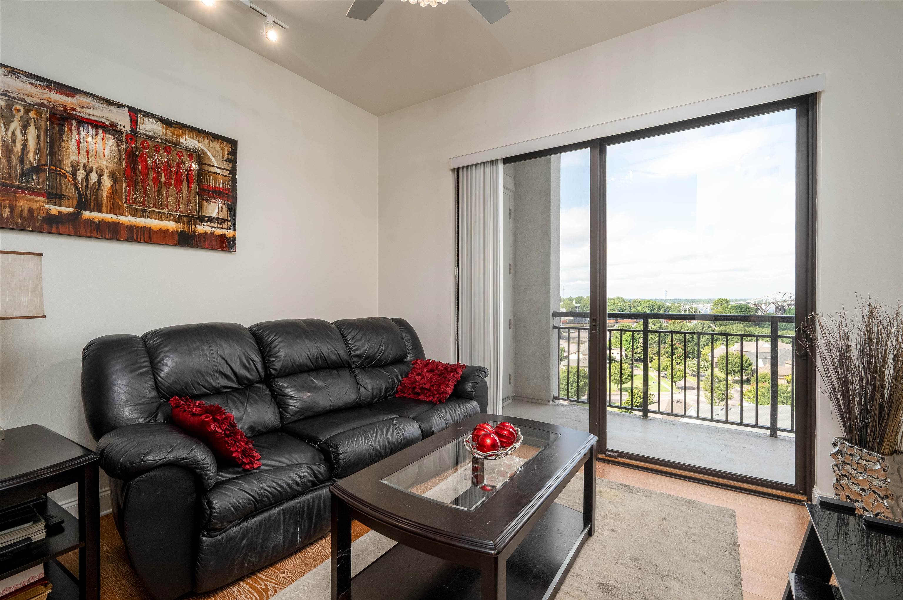 717 Riverside Drive, Unit 904 Memphis, TN 38103 - Photo 12 of 33 a living room with furniture and a floor to ceiling window