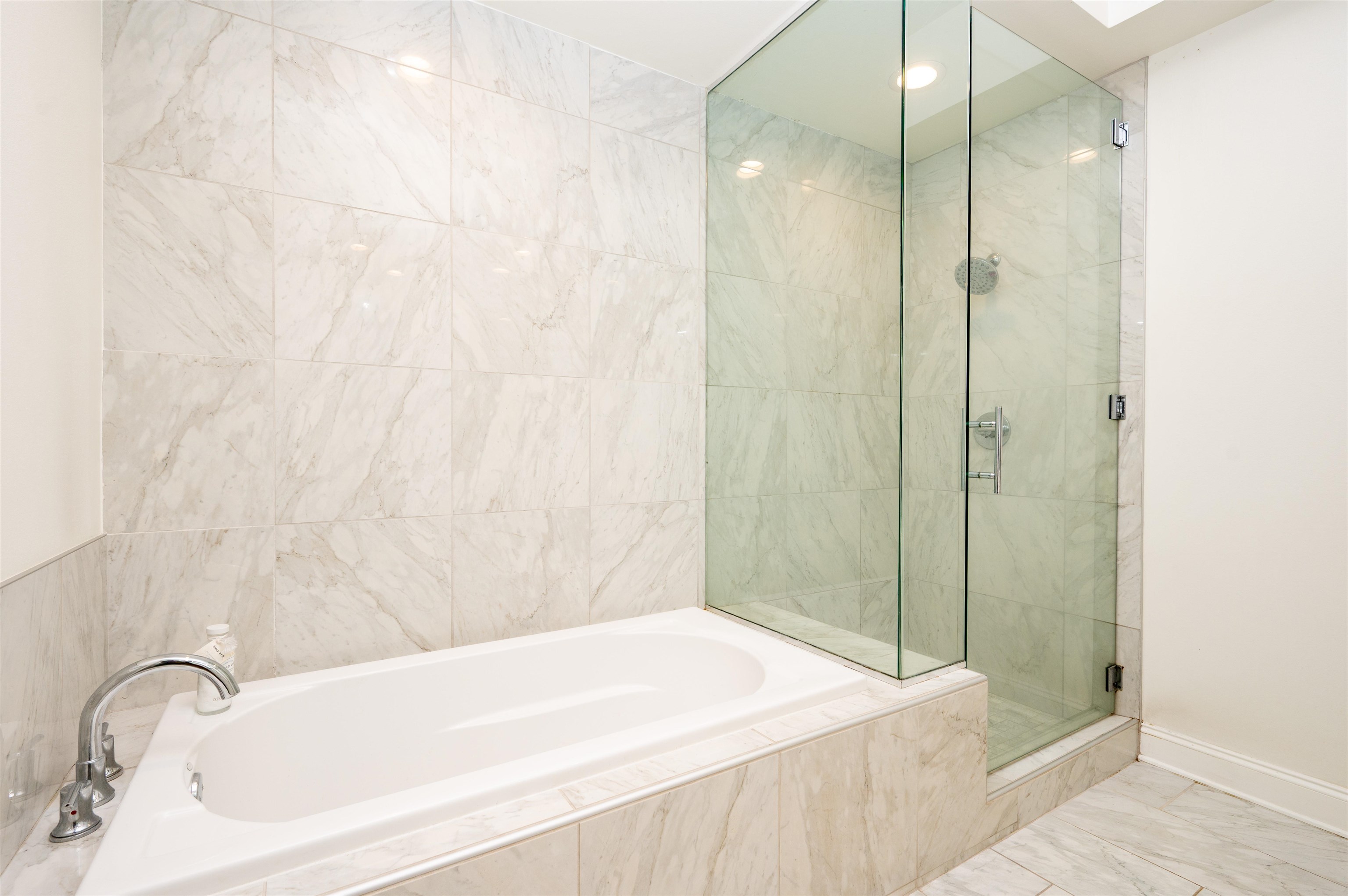 717 Riverside Drive, Unit 904 Memphis, TN 38103 - Photo 16 of 33 a bathroom with a bathtub and shower