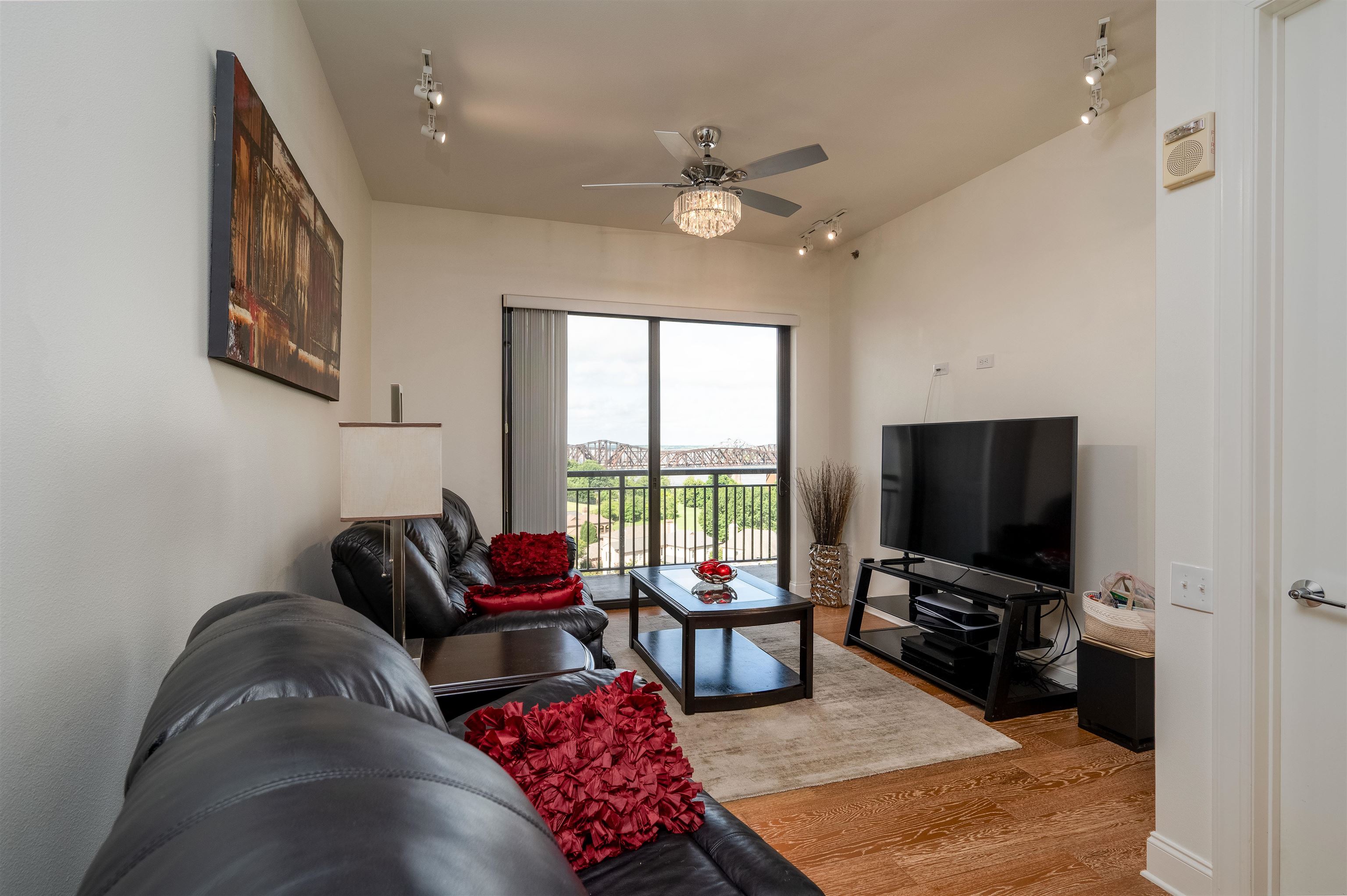 717 Riverside Drive, Unit 904 Memphis, TN 38103 - Photo 10 of 33 a living room with furniture and a flat screen tv