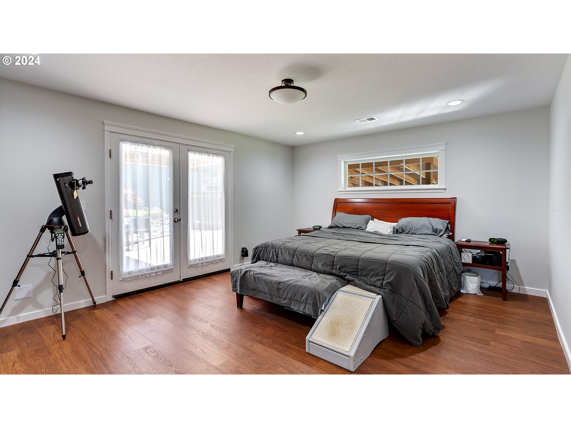 42142 Southeast Trubel Road Sandy, OR 97055 - Photo 15 of 48 a bedroom with a bed and wooden floor