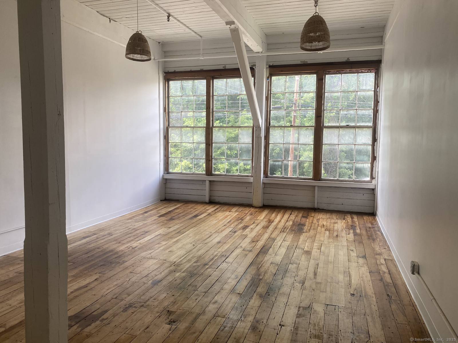 642 Hilliard Street, Unit 2104 Manchester, CT 06042 - Photo 1 of 1 a view of an empty room with wooden floor and a window
