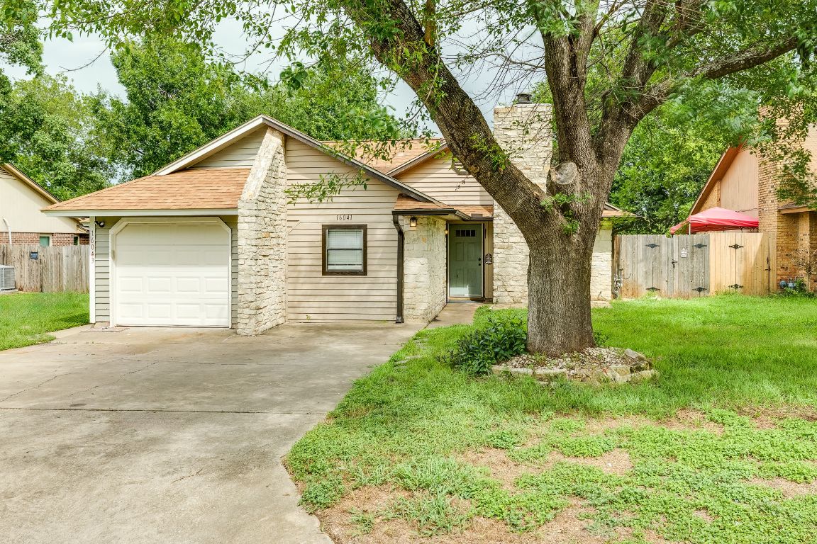 16041 Stoneham Circle Pflugerville, TX 78660 - Photo 1 of 34 a small white house with a yard and large trees