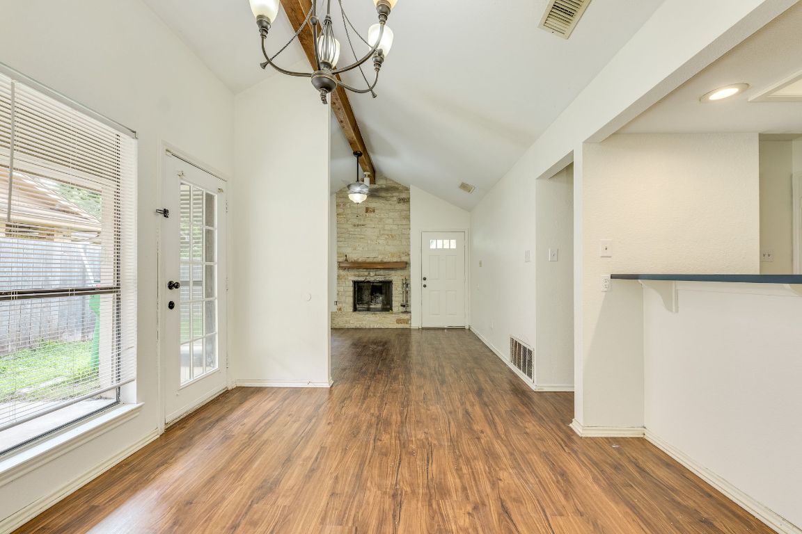 16041 Stoneham Circle Pflugerville, TX 78660 - Photo 13 of 34 a view of empty room with wooden floor and fan