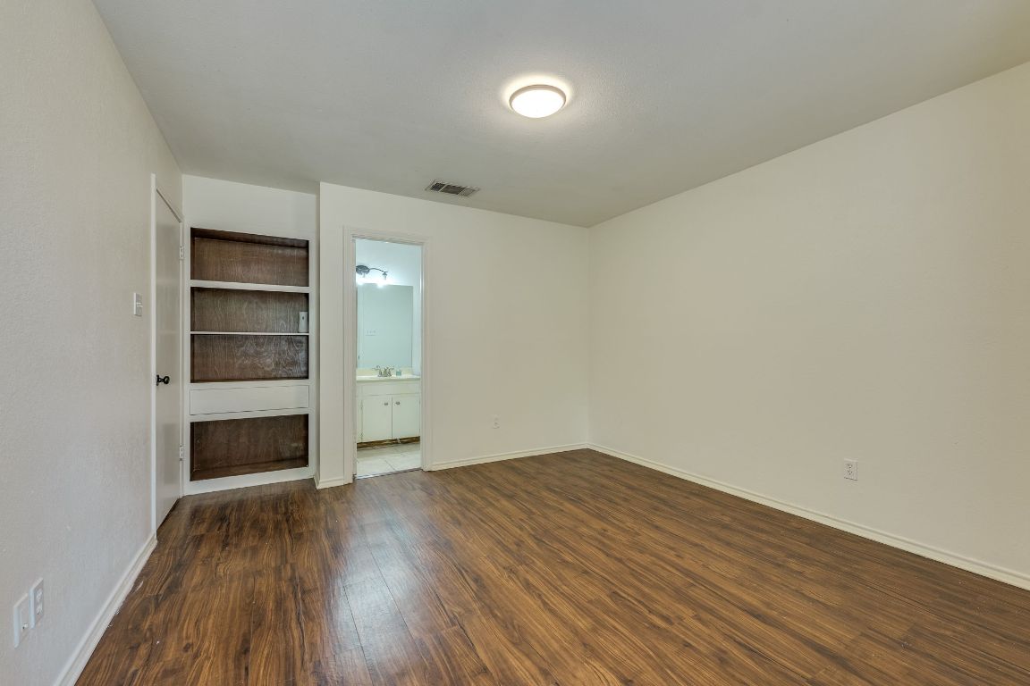 16041 Stoneham Circle Pflugerville, TX 78660 - Photo 17 of 34 an empty room with closet and wooden floor