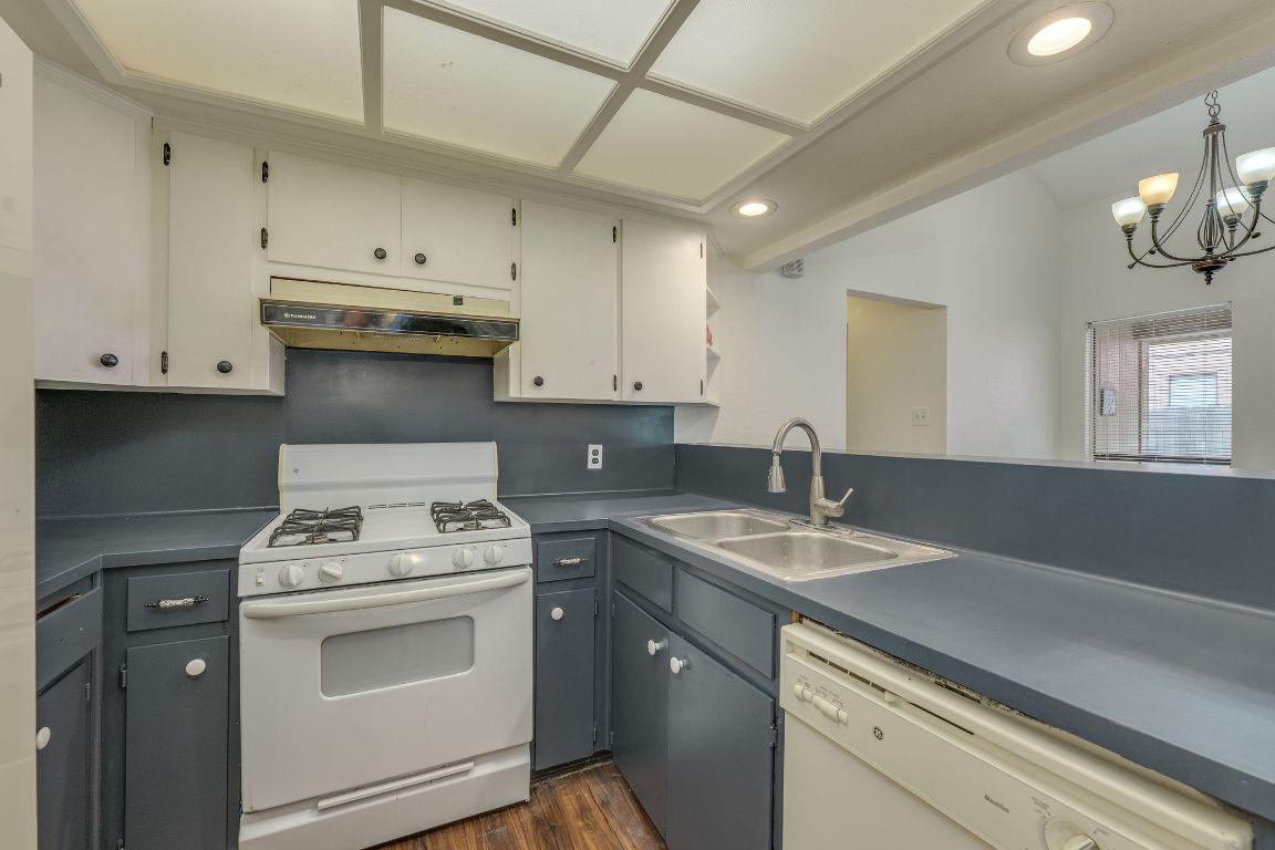 16041 Stoneham Circle Pflugerville, TX 78660 - Photo 22 of 34 a kitchen with a sink stove and cabinets