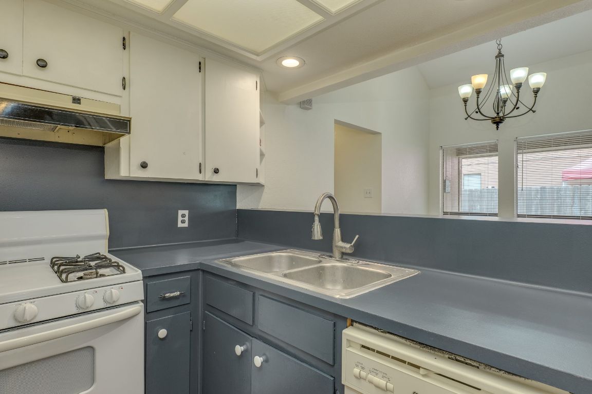 16041 Stoneham Circle Pflugerville, TX 78660 - Photo 24 of 34 a kitchen with a sink cabinets and appliances