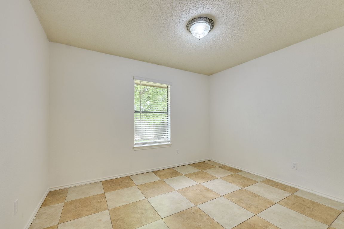 16041 Stoneham Circle Pflugerville, TX 78660 - Photo 27 of 34 an empty room with a empty space and a window