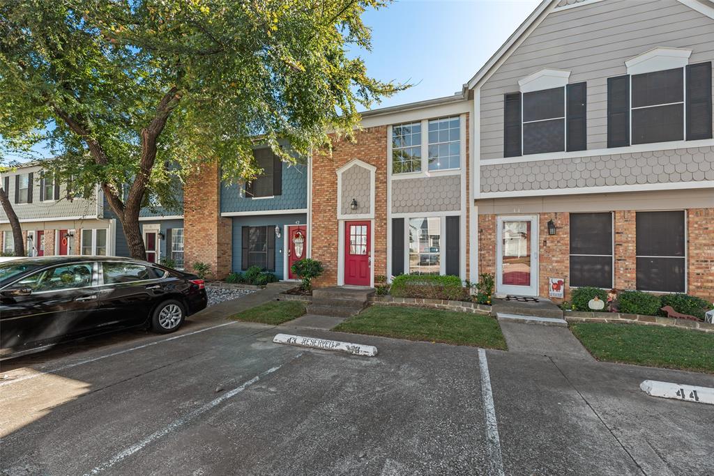 43 Abbey Road Euless, TX 76039 - Photo 1 of 22 a view of a brick house with a yard next to a road