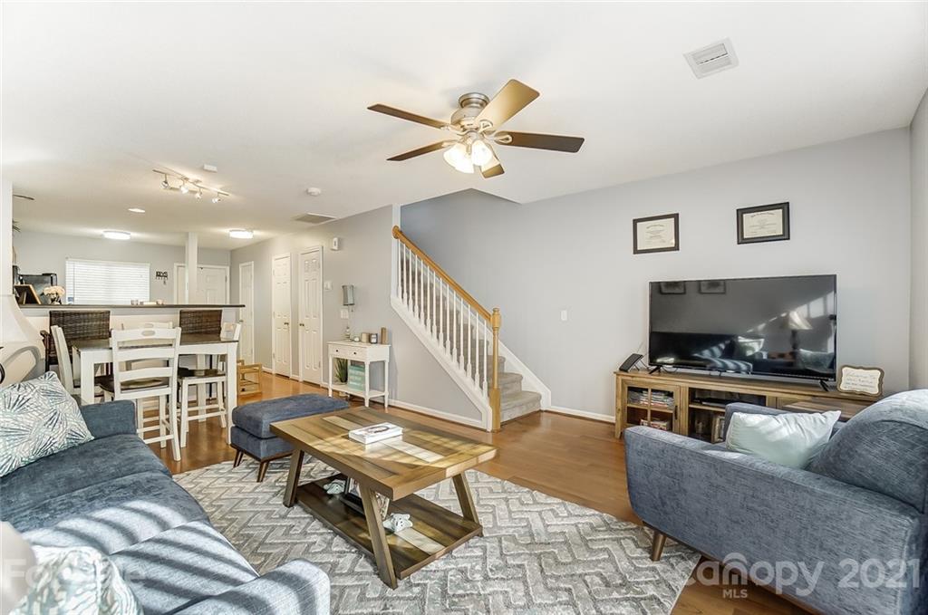 1545 Maypine Commons Way Rock Hill, SC 29732 - Photo 13 of 26 a living room with furniture and a flat screen tv with kitchen view