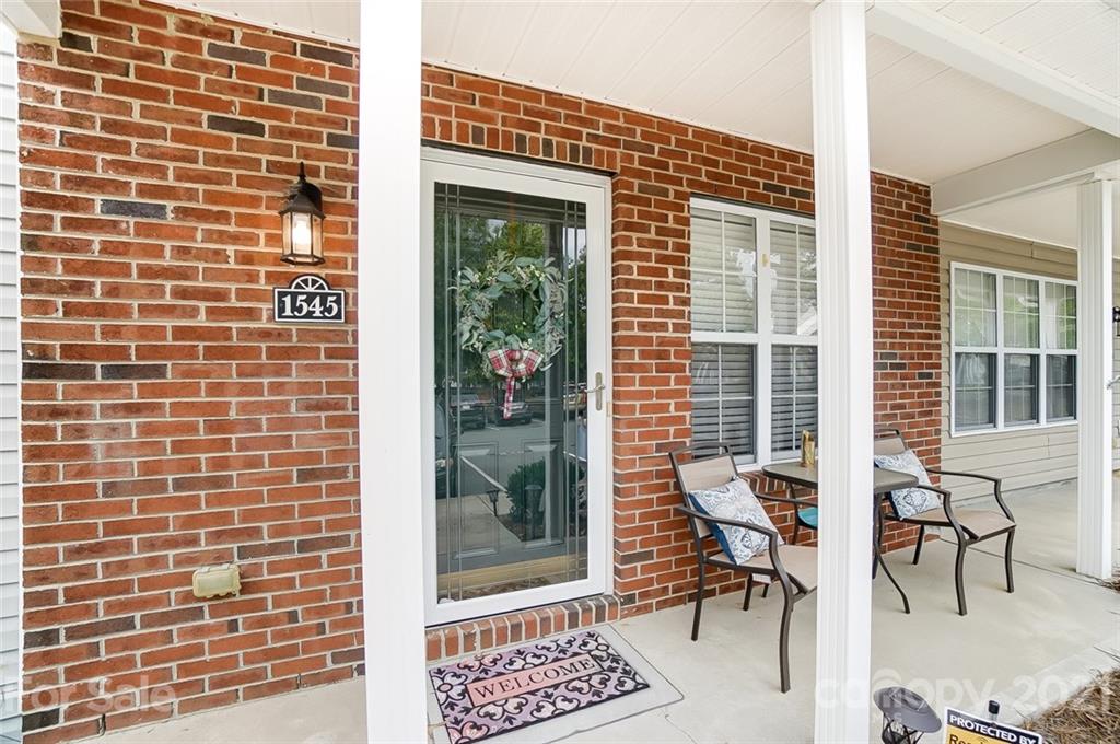 1545 Maypine Commons Way Rock Hill, SC 29732 - Photo 5 of 26 a view of a patio with a table and chairs and potted plants