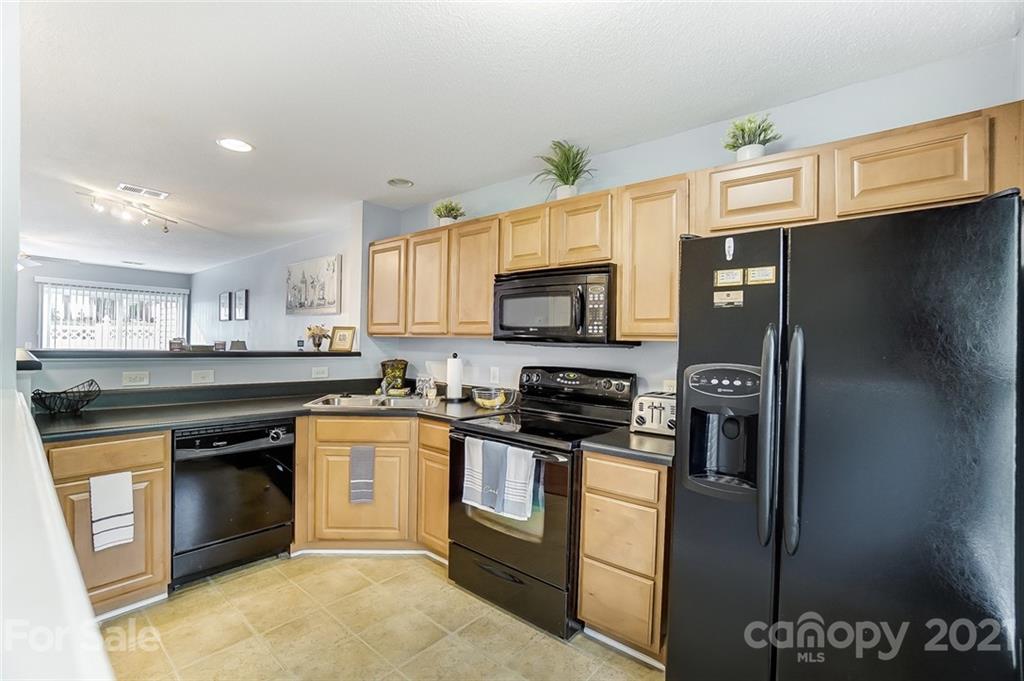 1545 Maypine Commons Way Rock Hill, SC 29732 - Photo 7 of 26 a kitchen with stainless steel appliances granite countertop a stove a sink dishwasher a refrigerator and a microwave
