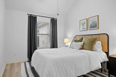 a bedroom with a bed and a window