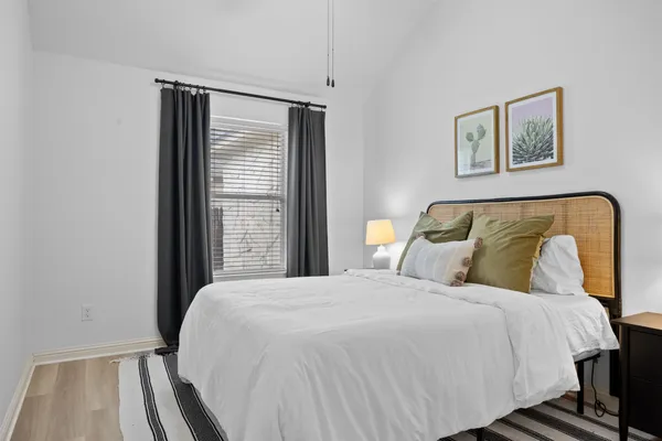 a bedroom with a bed and a window