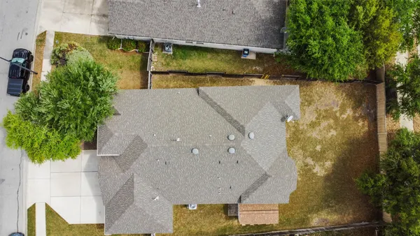 an aerial view of residential houses with outdoor space