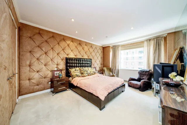 a bedroom with a bed and a couch